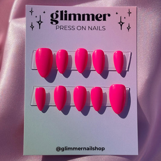 Glimmer press-on nails packaging with pink nails on a pink background