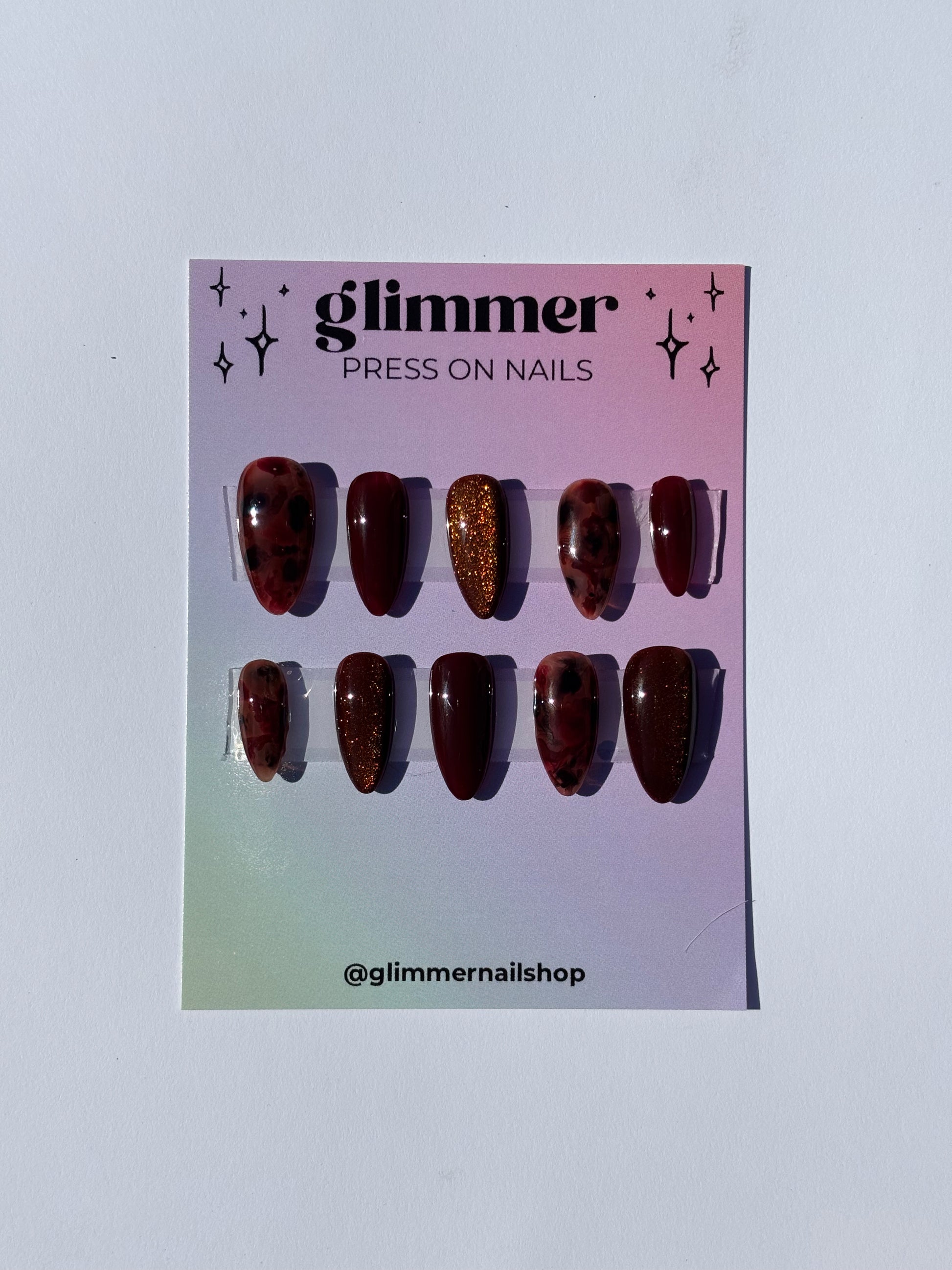 Glimmer press on nails set, featuring maroon and glitter designs, easy application, stylish and durable.