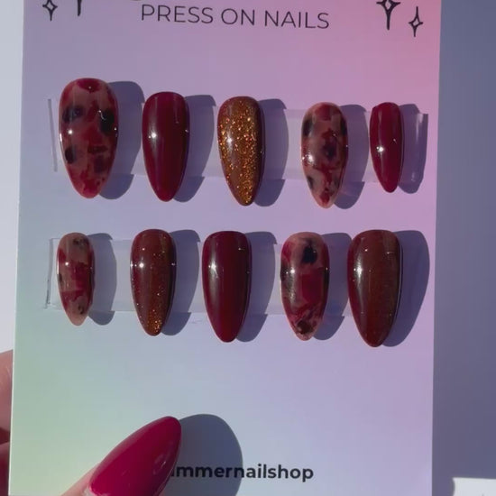 Glimmer press-on nails set with burgundy and glitter designs, stylish and easy-to-apply nail art.