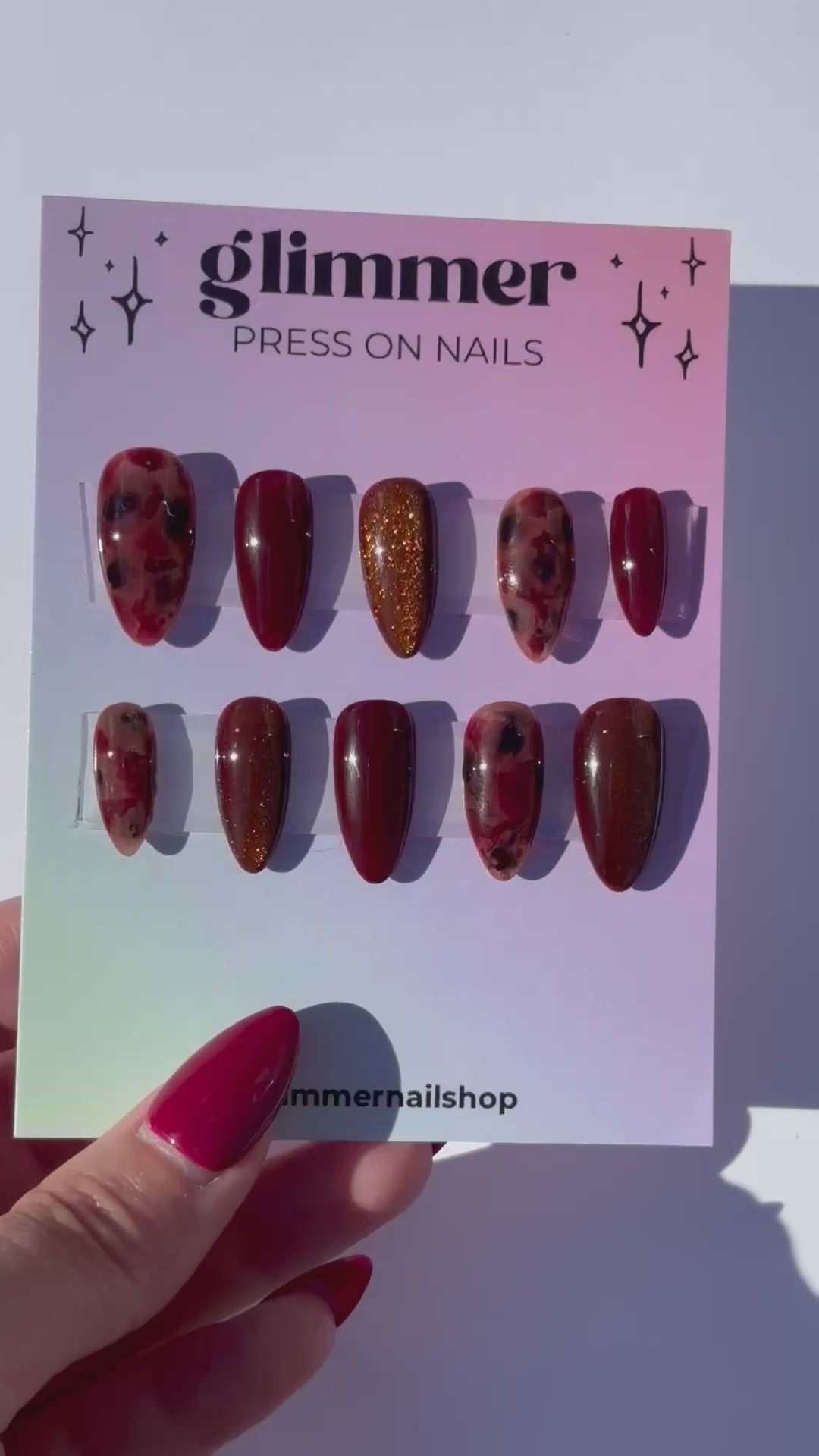 Glimmer press-on nails set with burgundy and glitter designs, stylish and easy-to-apply nail art.